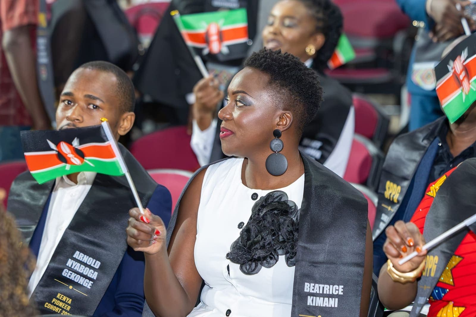 Graduates wave the Kenyan flag at the pioneer ceremony