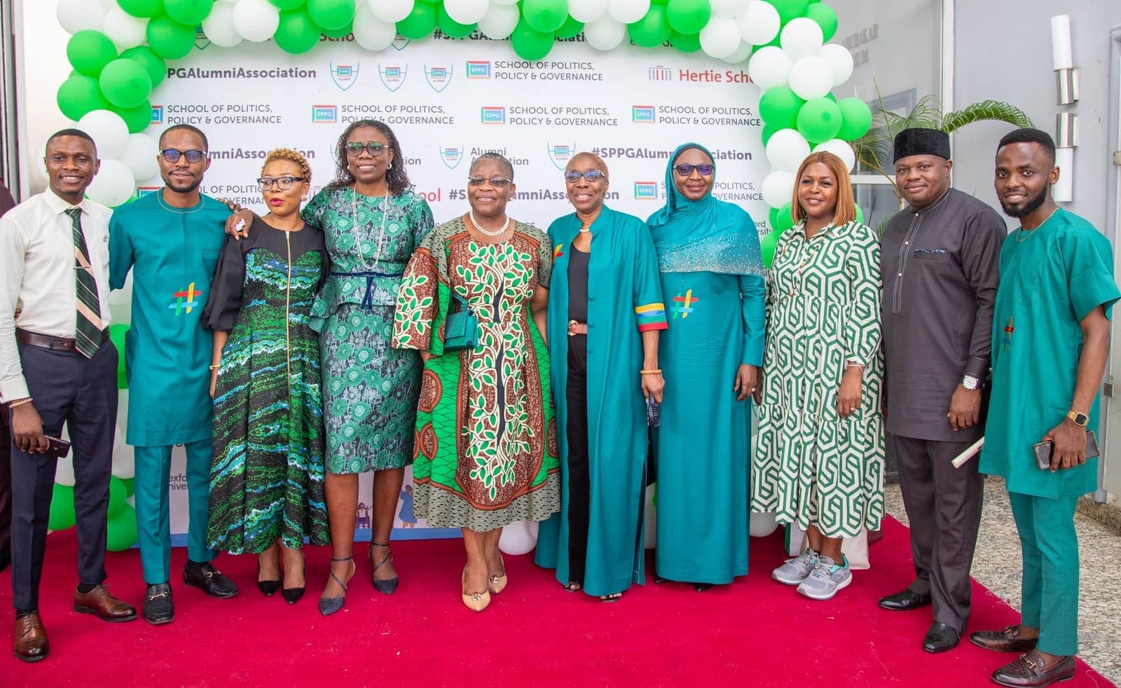Graduates and faculty at the step-and-repeat