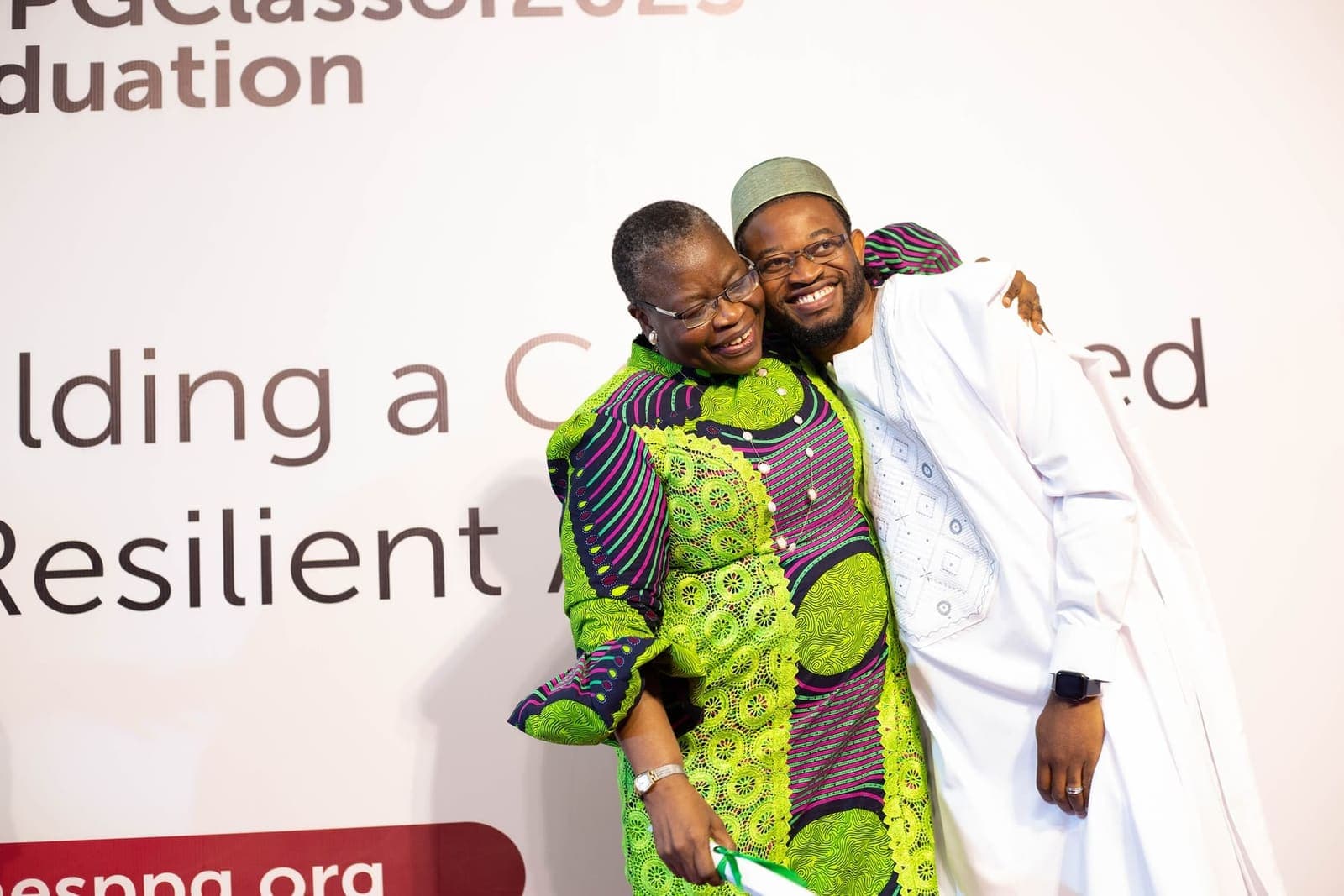 A graduate is congratulated on stage