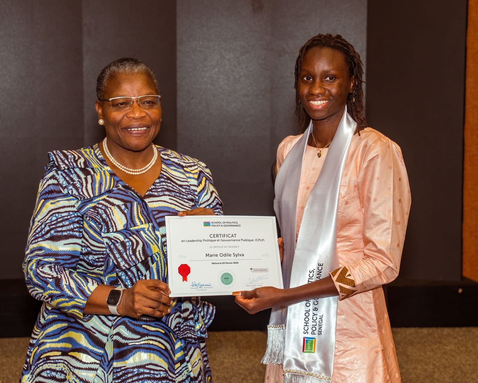 A graduate receives her certificate